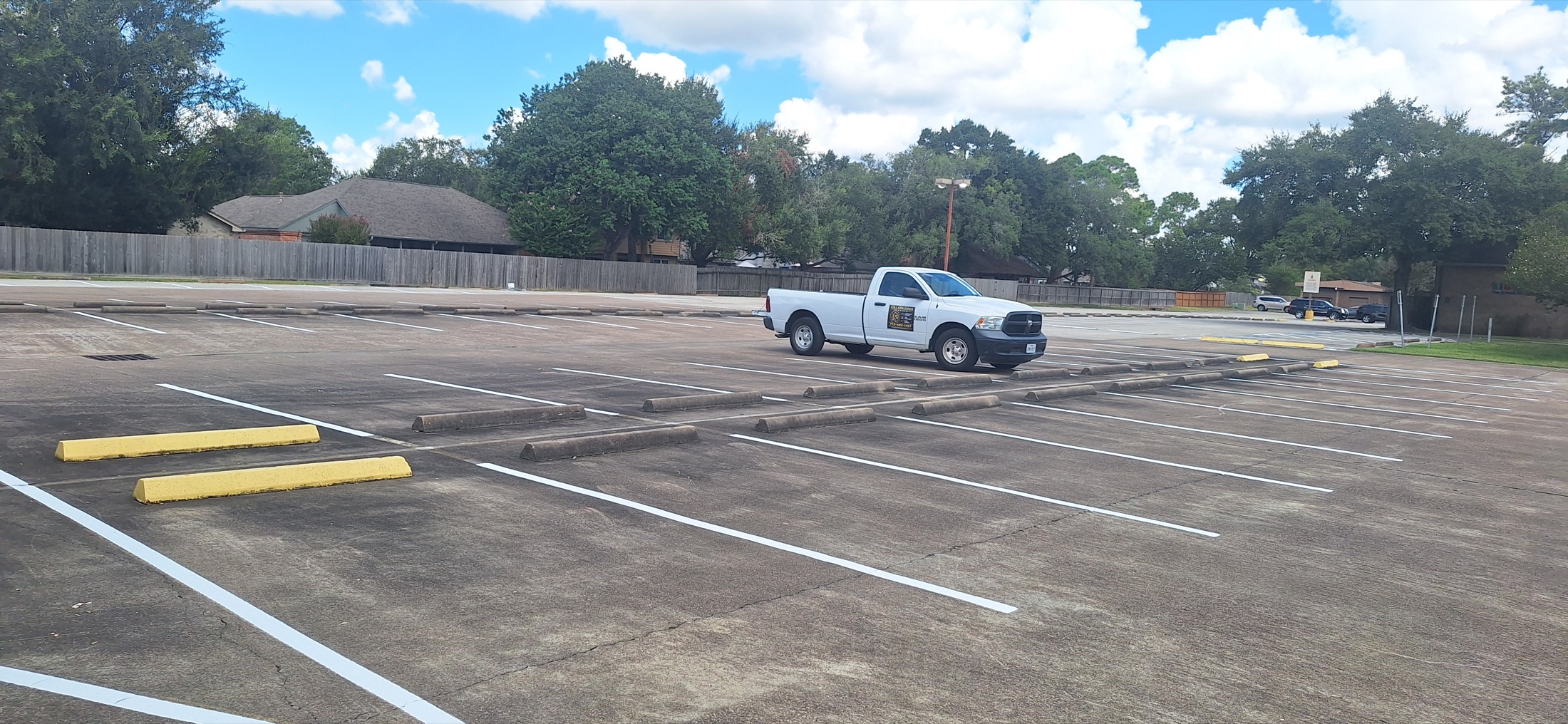 Lollalpalooza Services truck surrounded by completed white parking lines